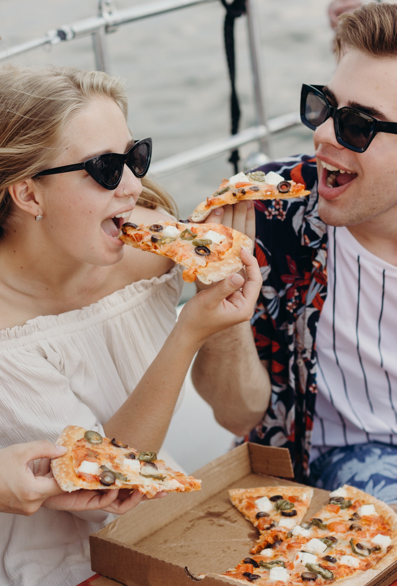 a couple eating pizza together